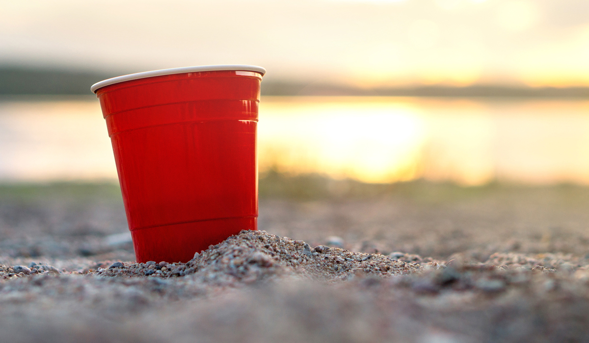 Red cup in sand